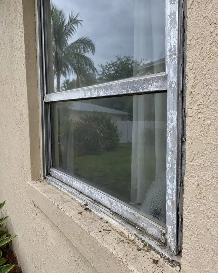 Old aluminum window frame with white corrosion
